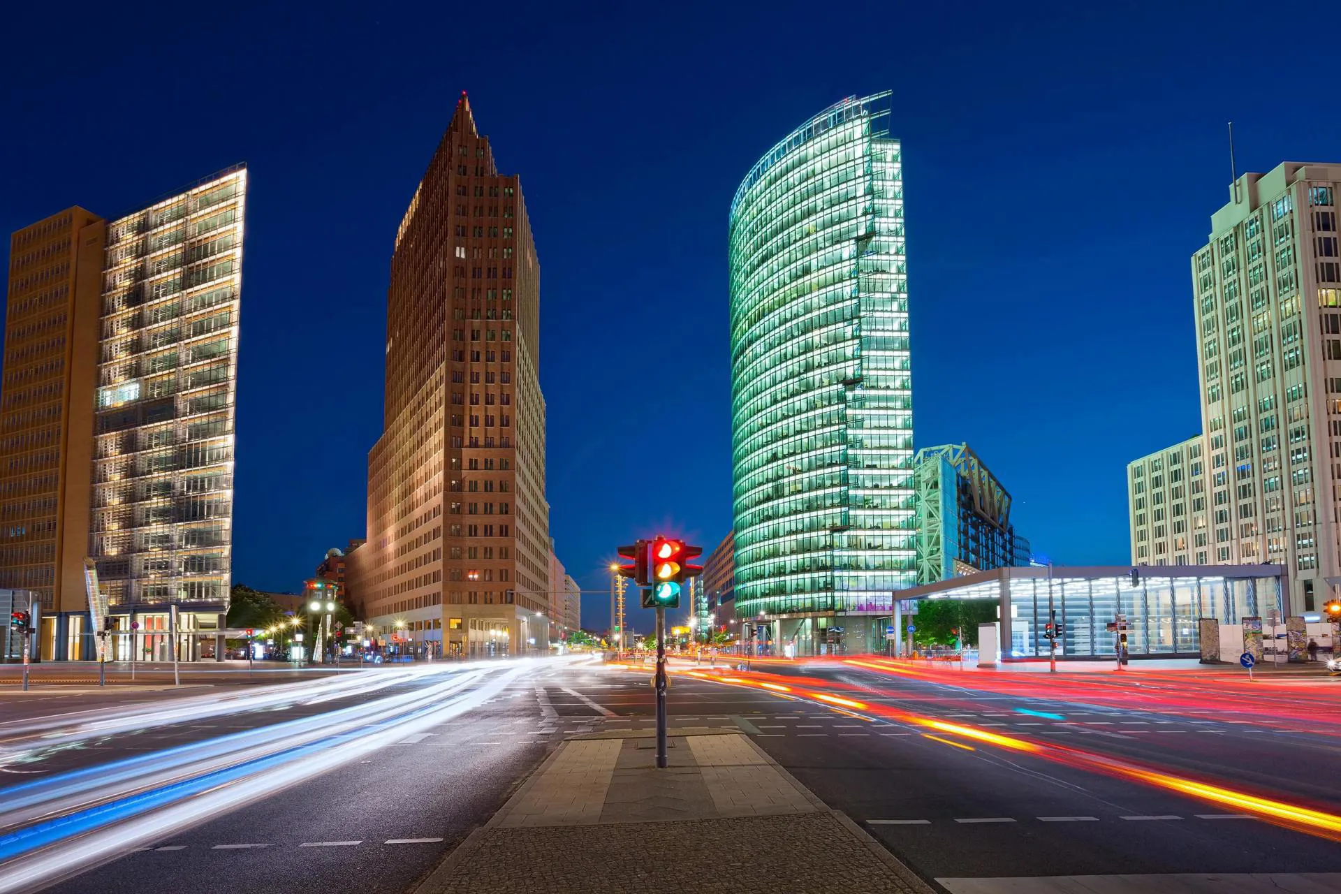 Potsdamer Platz in Berlin at an intersection with a traffic light on it.