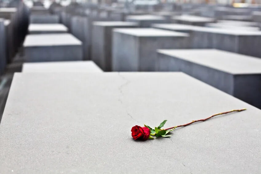A single red rose laid down on a memorial pillar at the Jewish Holocaust Memorial in Berlin, Germany.