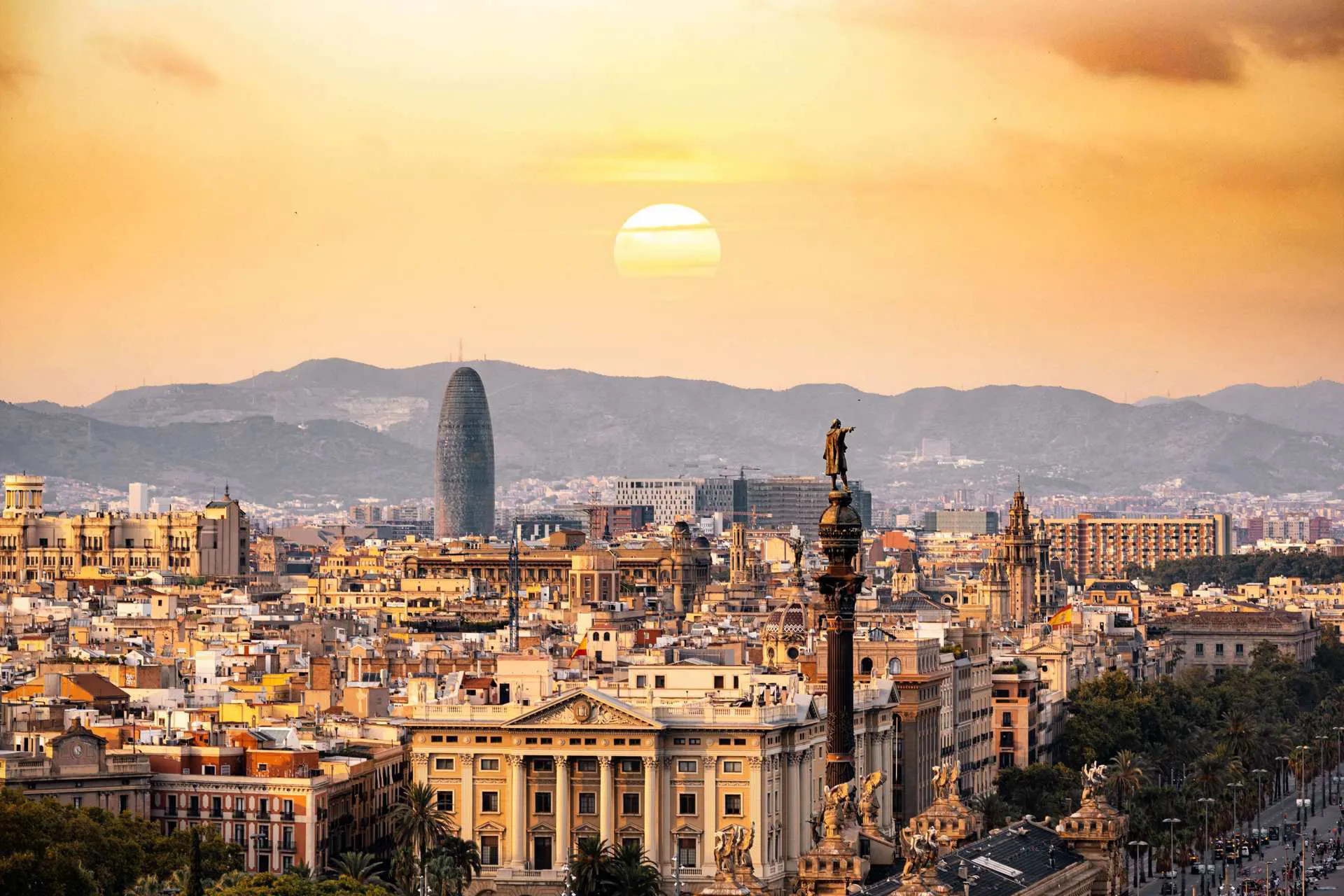 A view of Barcelona city as the suns sets in over the mountains.