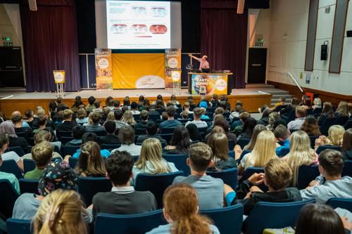An auditorium with a large class looking at a projected map of the world at the Earth Summit.