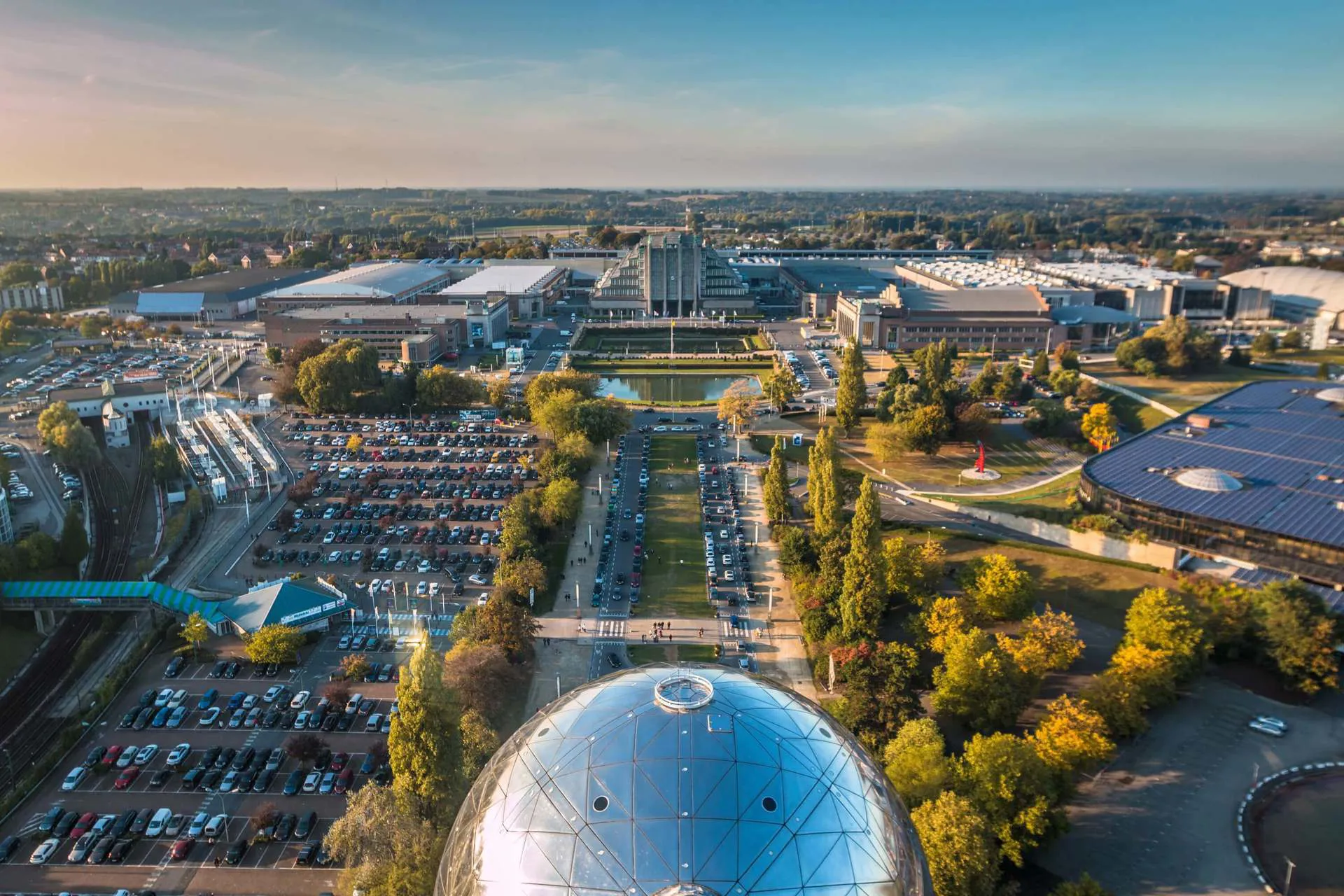 A view of Brussels Atomium and a large car park to the left.