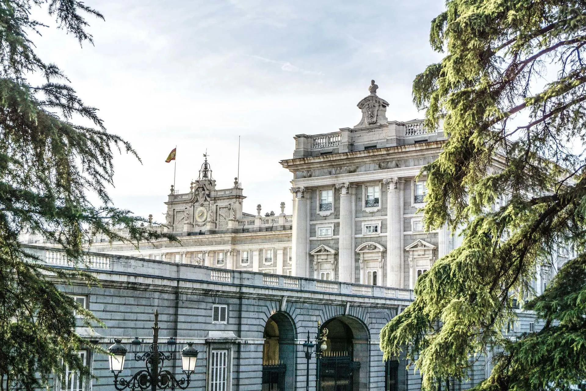 A large white building in Madrid, with the Spanish flag flying from the top
