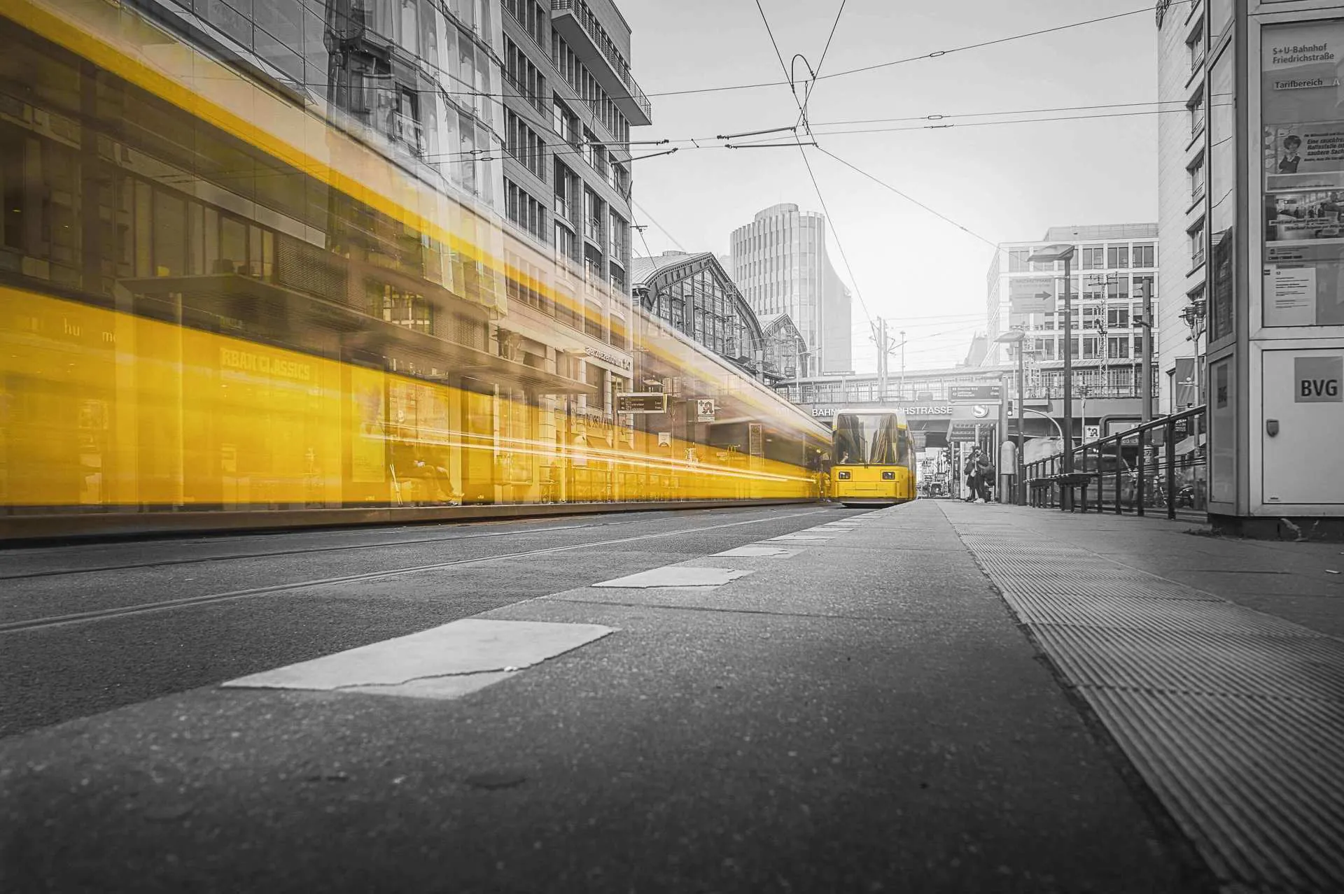 Blurred images of yellow trains pass either way across the city of Berlin.
