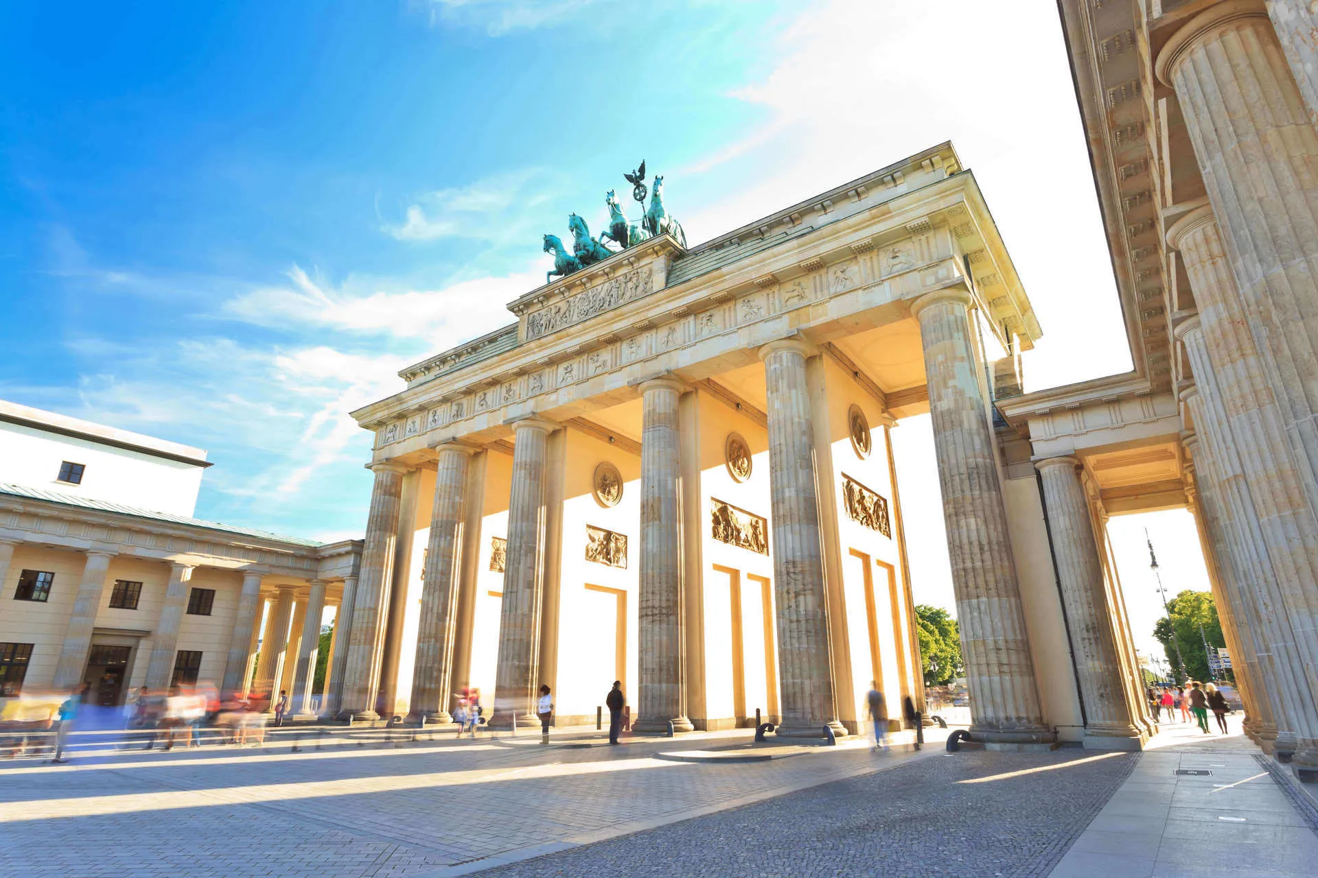 The sun shines through Brandenburg Gate in Berlin, Germany.