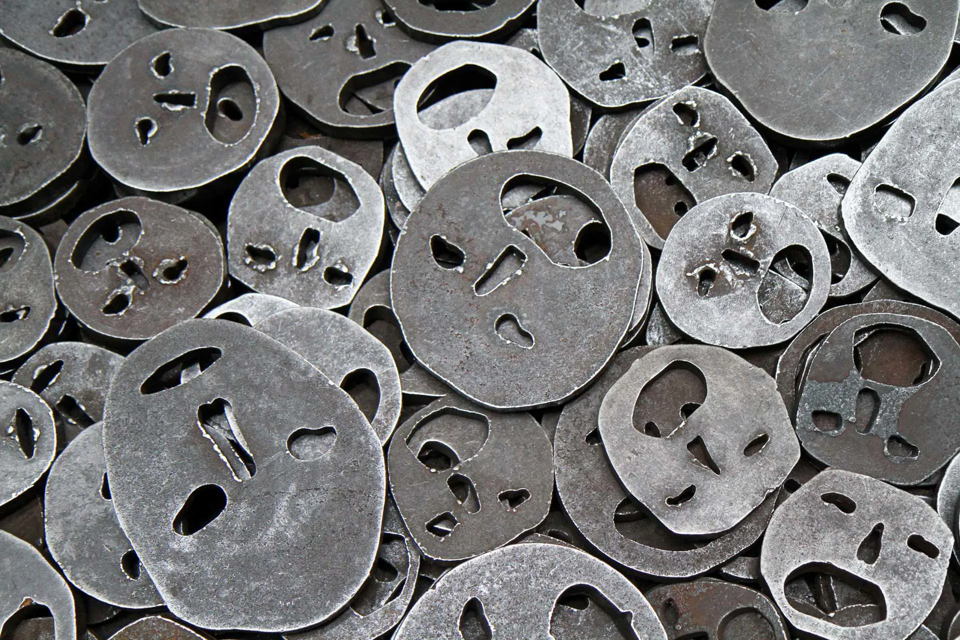 An exhibit in the Berlin Jewish Museum, showing metal plates that make out faces.