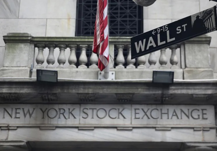The New York Stock Exchange draped with an American flag.