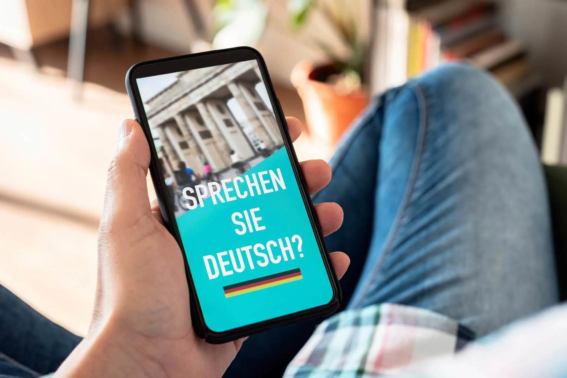 A view of a phone, with the Brandenburg Gate and the words 'Sprechen sie Deutsch' written on it.
