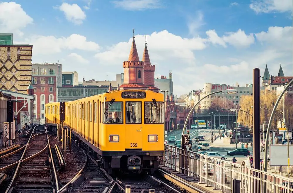 A yellow bus passes over a bridge in Berlin.